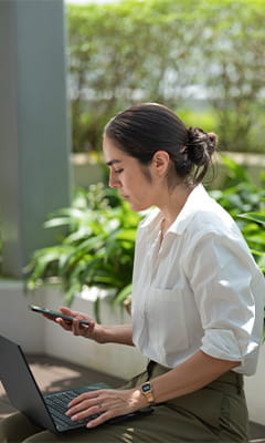 a woman sitting surrounded by greens